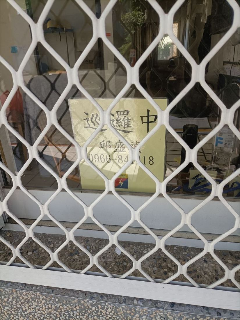 巡邏中告示牌掛在警衛室窗戶鐵窗上